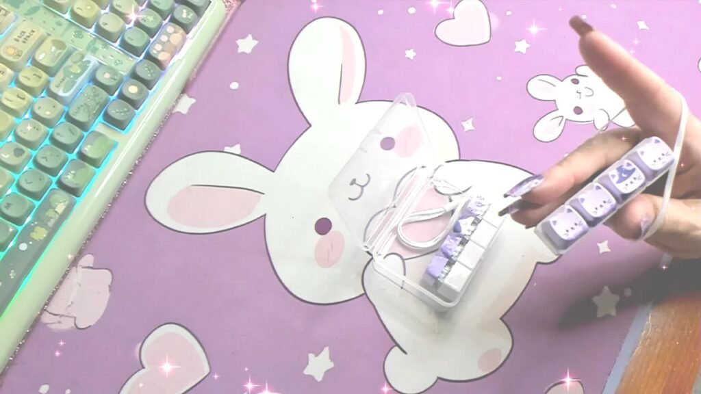 Dr. Elena holding her purple four-key cat clicker in a still from her own video