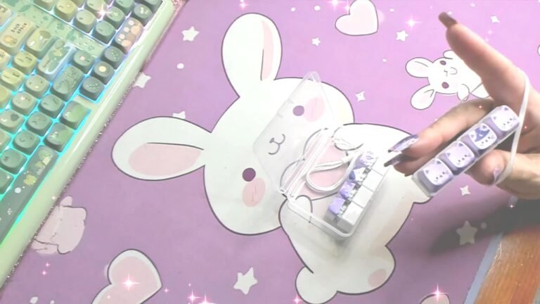 Dr. Elena holding her purple four-key cat clicker in a still from her own video