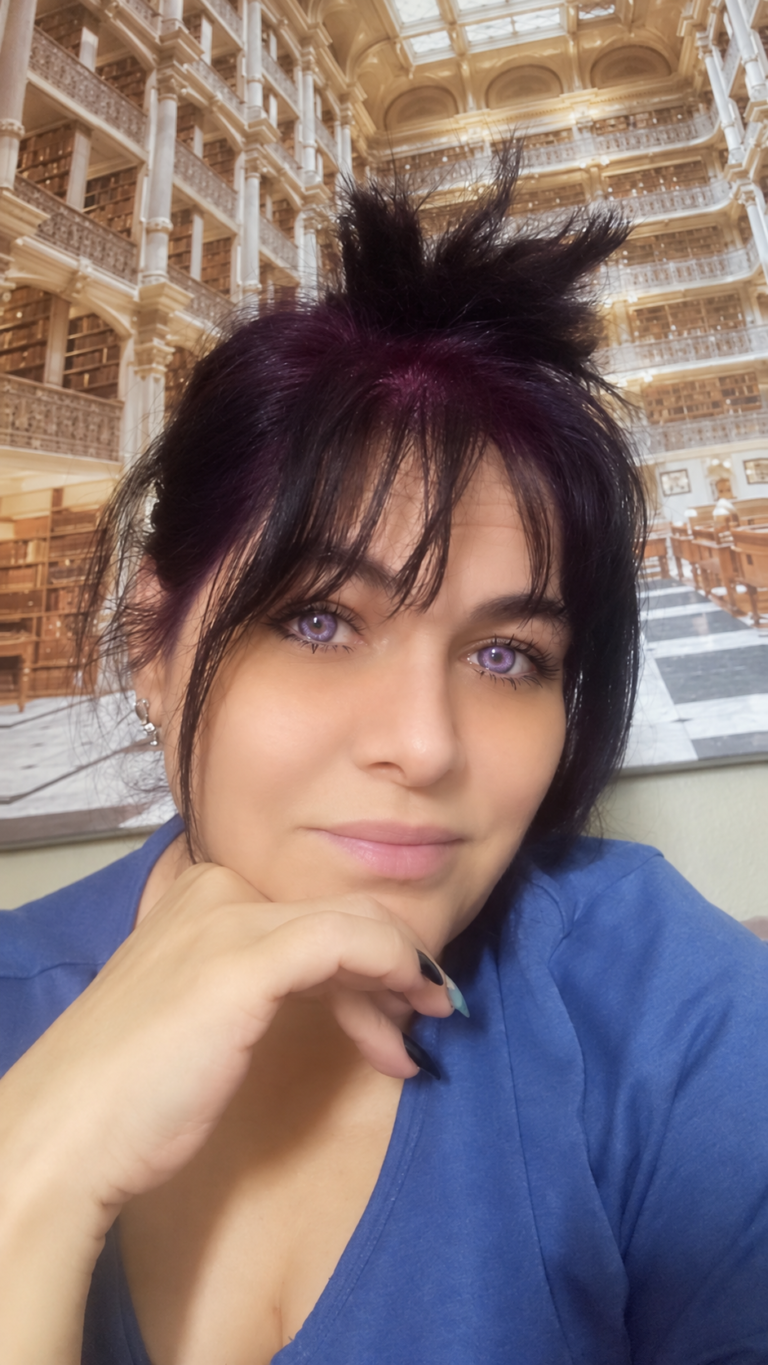 Dr. Elena wearing her hair color and violet-looking contacts in her own photograph.